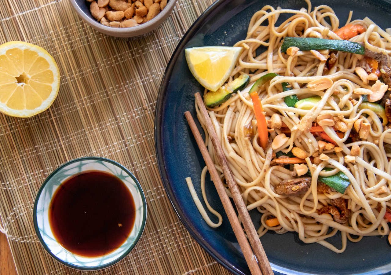 traditional chinese dish with chopsticks on a bamboo placemat